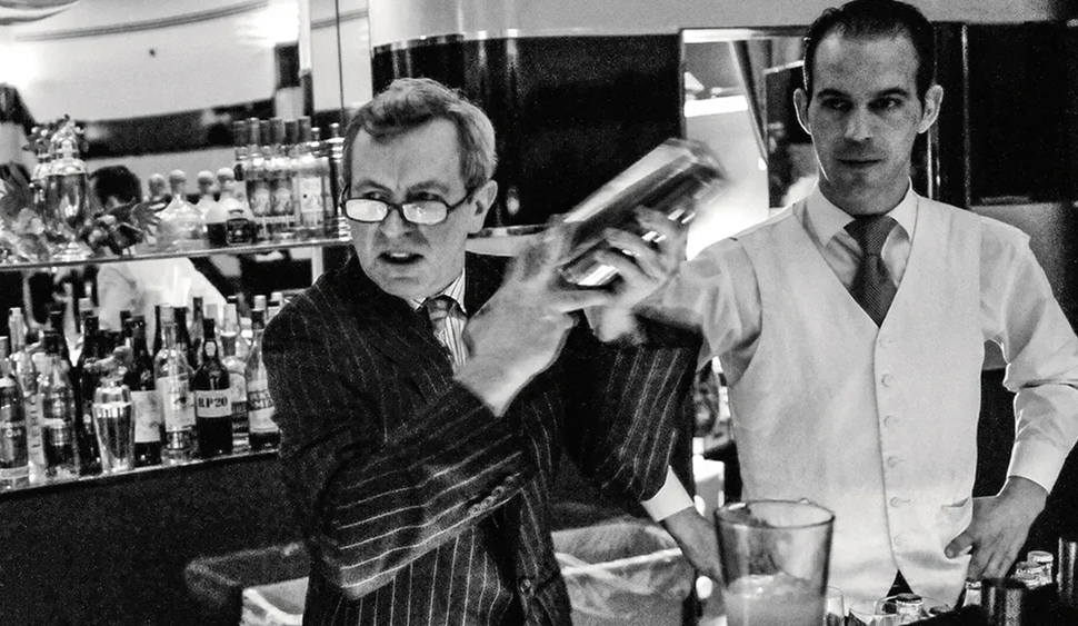 Bartender shaking a cocktail behind the bar